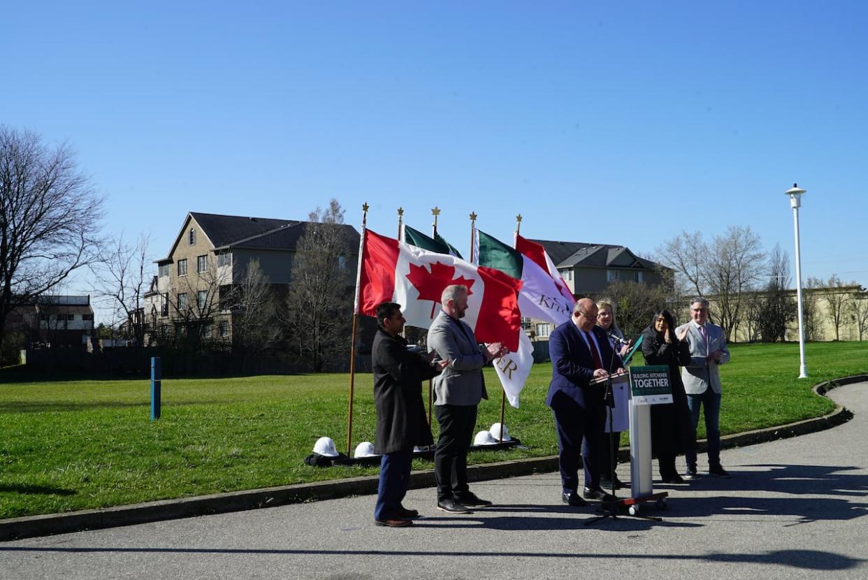 Kitchener has donated almost one hectare of land to Habitat for Humanity as part of the non-profit's Build Now: Waterloo Region initiative. The donated land can be seen behind local politicians. (Carmen Groleau/CBC - image credit)