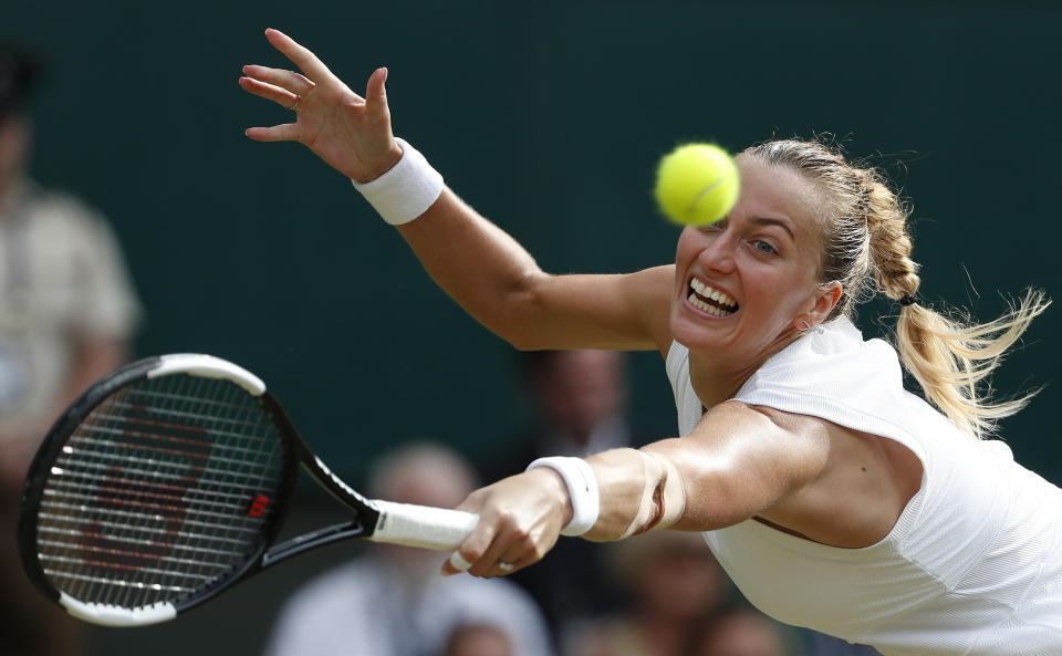 FILE - In this July 19, 2019, file photo, Czech Republic's Petra Kvitova returns to Britain's Johanna Konta in a singles match at the Wimbledon Tennis Championships in London. Kvitova will be competing in the Australian Open tennis tournament, beginning Monday, Jan. 20, 2020. (AP Photo/Alastair Grant, File)