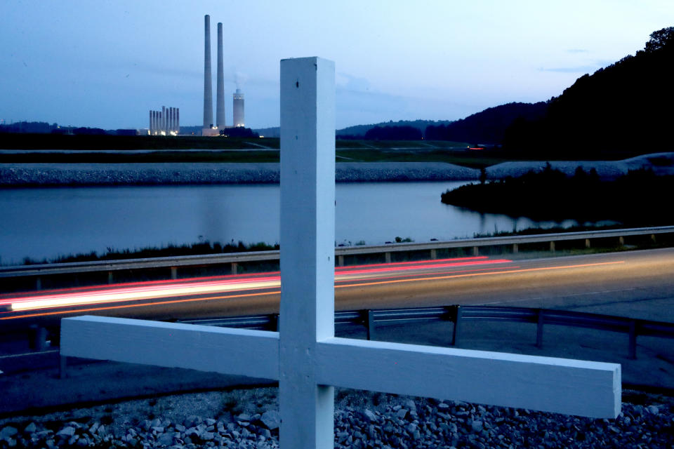 FILE - A memorial built by Ansol Clark stands across a waterway from the Kingston Fossil Plant, on Aug. 6, 2019, in Kingston, Tenn. Attorneys for a group of workers who believe their jobs cleaning up a massive coal ash spill in Tennessee led to a slew of illnesses, including fatal cancers, have reached a settlement with the contractor who organized the cleanup for the Tennessee Valley Authority, according to a notice posted on the Jacobs Engineering website on Tuesday, May 23, 2023. (AP Photo/Mark Humphrey, File)
