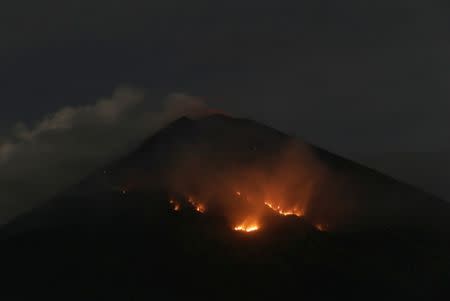 Fire is seen on the slopes of Mount Agung volcano following an eruption as seen from Amed in Karangasem Regency, Bali, Indonesia July 3, 2018. REUTERS/Johannes P. Christo