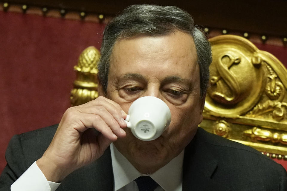 Italian Premier Mario Draghi drinks a coffee after he delivered his speech at the Senate in Rome, Wednesday, July 20, 2022. Draghi was deciding Wednesday whether to confirm his resignation or reconsider appeals to rebuild his parliamentary majority after the populist 5-Star Movement triggered a crisis in the government by withholding its support. (AP Photo/Andrew Medichini)