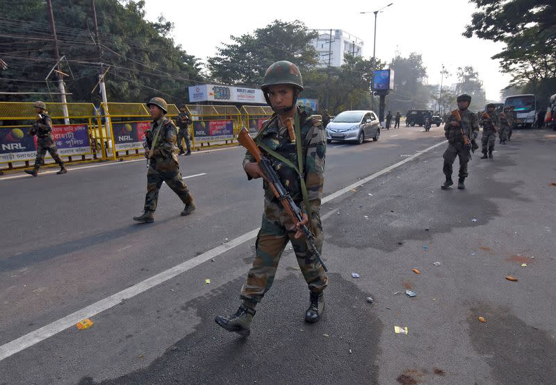 Soldiers patrol a street following protests after India's parliament passed Citizenship Amendment Bill, in Guwahati