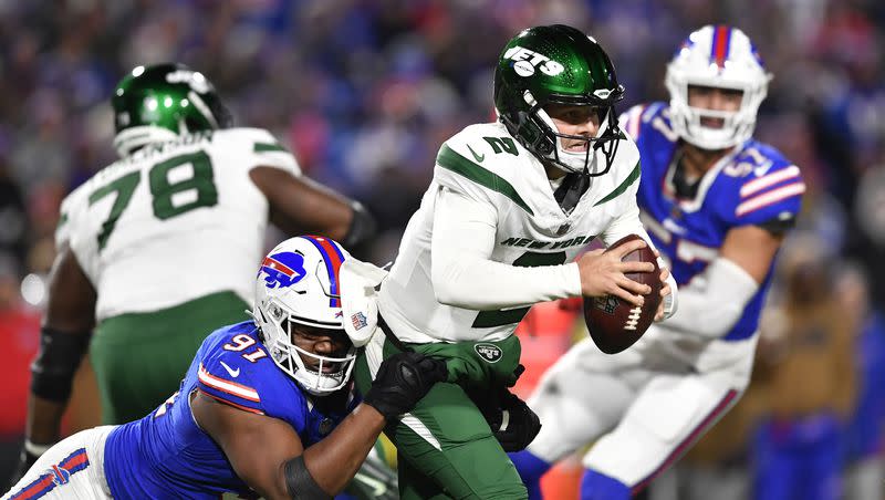 New York Jets quarterback Zach Wilson (2) is sacked by Buffalo Bills defensive tackle Ed Oliver (91) during the second half of an NFL football game in Orchard Park, N.Y., Sunday, Nov. 19, 2023. 