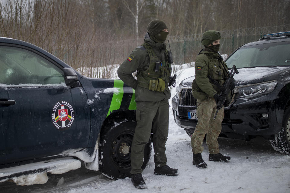 Members of the Lithuania State Border Guard Service and Lithuanian army soldiers patrol on the border with Belarus during a visit by participants of the Conference on Border Management near the village Kurmelionys, some 40km (24 miles) east of the capital Vilnius, Lithuania, Friday, Jan. 21, 2022. The conference main objective is to discuss issues of fundamental importance in an open and informal way and to find common denominators on the issues of the protection of external borders, the response to hybrid attacks and the elimination of abuses of the EU asylum system. (AP Photo/Mindaugas Kulbis)