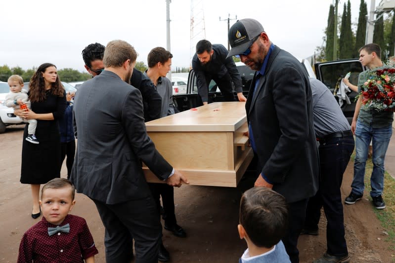 Relatives of Christina Marie Langford Johnson, who was killed by unknown assailants, carry her coffin during the funeral service before a burial at the cemetery in LeBaron, Chihuahua