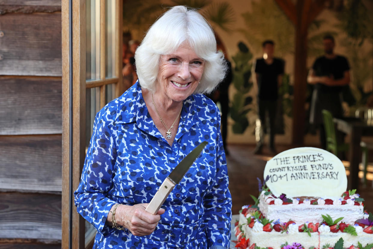 The Duchess of Cornwall prepares to cut a cake to mark the 