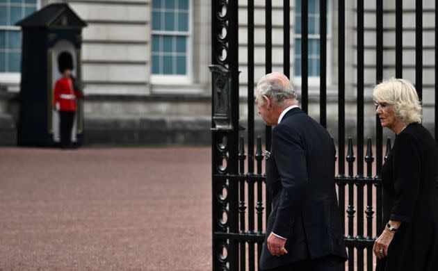 King Charles III and Camilla, Queen Consort, walk into Buckingham Palace after greeting the crowd and looking at floral tributes on Sep. 9. (Photo: BEN STANSALL via Getty Images)