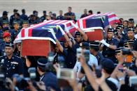 Malaysian police carry the coffins of two dead officers killed in an ambush in Semporna, at the Subang Royal Malaysian Air Force base in Kuala Lumpur on March 4, 2013. Malaysia's military has launched a fierce assault including jet fighters on up to 300 Filipino intruders after a deadly three-week standoff, but the militants' supporters said they had escaped and were alive and well