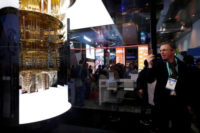 FILE PHOTO: A man takes a photo of a model of the IBM Q System One quantum computer during the 2020 CES in Las Vegas