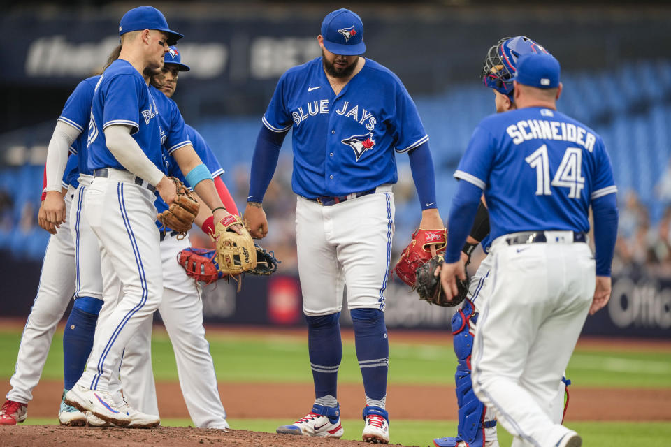 Toronto Blue Jays starting pitcher Alek Manoah (6) steps off the mound before being pulled by manager John Schneider (14) against the Houston Astros in the first inning of a baseball game, in Toronto, Monday, June 5, 2023. (Andrew Lahodynskyj/The Canadian Press via AP)