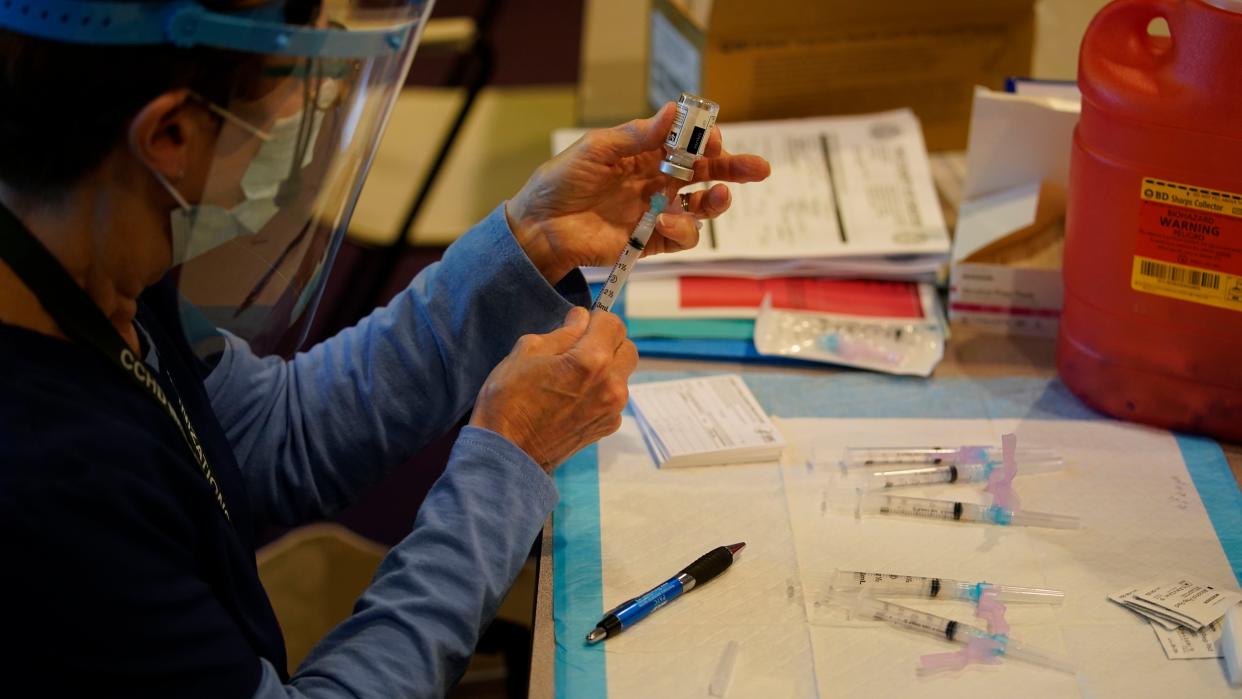 Pat Moore, with the Chester County, Pa., Health Department, fills a syringe with Moderna COVID-19 vaccine before administering it to emergency medical workers and healthcare personnel at the Chester County Government Services Center, Tuesday, Dec. 29, 2020, in West Chester, Pa.