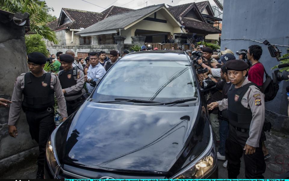 Indonesian police escort the car which Schapelle Corby is in as she prepares for deportation  - Credit: Ulet Ifansasti/Getty