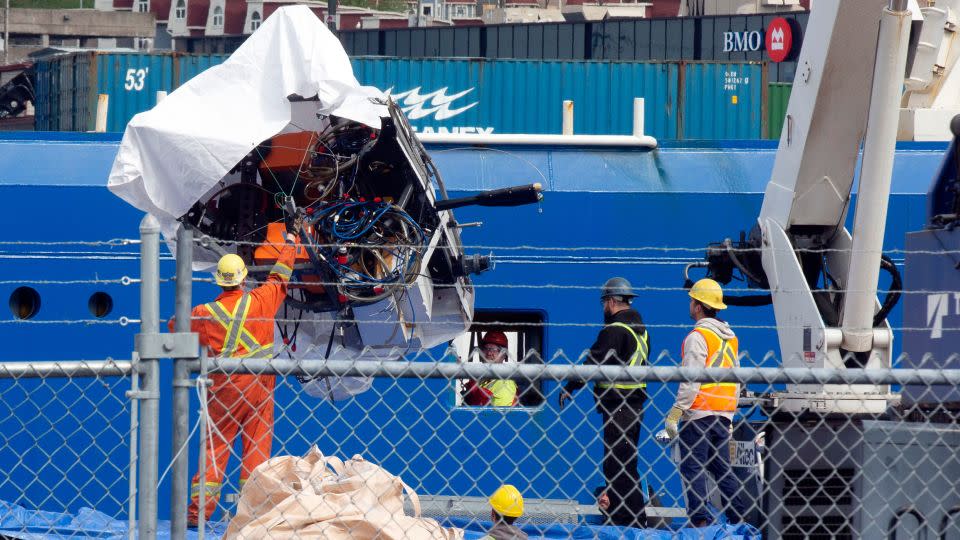 Titan debris brought up from the ocean floor is unloaded Wednesday from the Horizon Arctic ship. - Paul Daly/The Canadian Press/AP