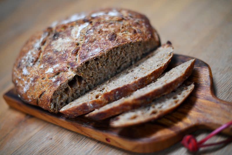 A first-attempt at a homemade seeded sourdough loaf is seen on a kitchen table in London