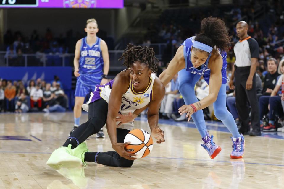 Sparks forward Nneka Ogwumike keeps the ball away from Chicago Sky forward Candace Parker.