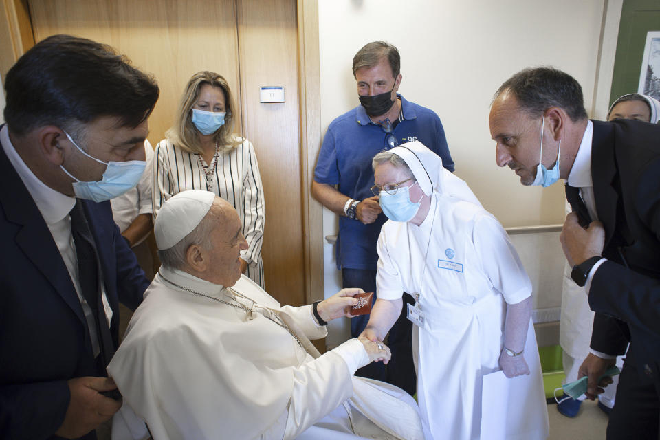 FILE-- Pope Francis is greeted by a nun as he sits in a wheelchair inside the Agostino Gemelli University Polyclinic in Rome, Sunday, July 11, 2021, where he was hospitalized for intestine surgery. The Vatican said Francis, 86, would be put under general anesthesia for the procedure Wednesday afternoon, June 07, 2023, and would be hospitalized at Rome's Gemelli hospital for several days. (Vatican Media via AP)