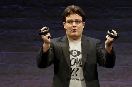 Oculus Founder Palmer Luckey displays an Oculus Touch input during an event in San Francisco, California June 11, 2015. REUTERS/Robert Galbraith