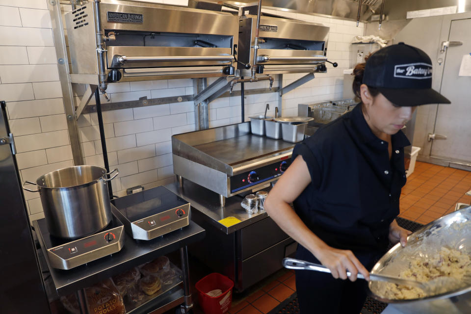 In this Thursday, Sept. 12, 2019 photo, primarily electric appliances line the kitchen of Batesy's restaurant in the Rockaway section of New York. Businesses and homeowners are getting caught in the middle as a utility presses state regulators to approve a natural gas pipeline between New York and New Jersey. The showdown has hurt people like Chris Miles, whose new barbecue restaurant in Rockaway Beach missed the summer season after it was denied a new gas hookup. (AP Photo/Seth Wenig)