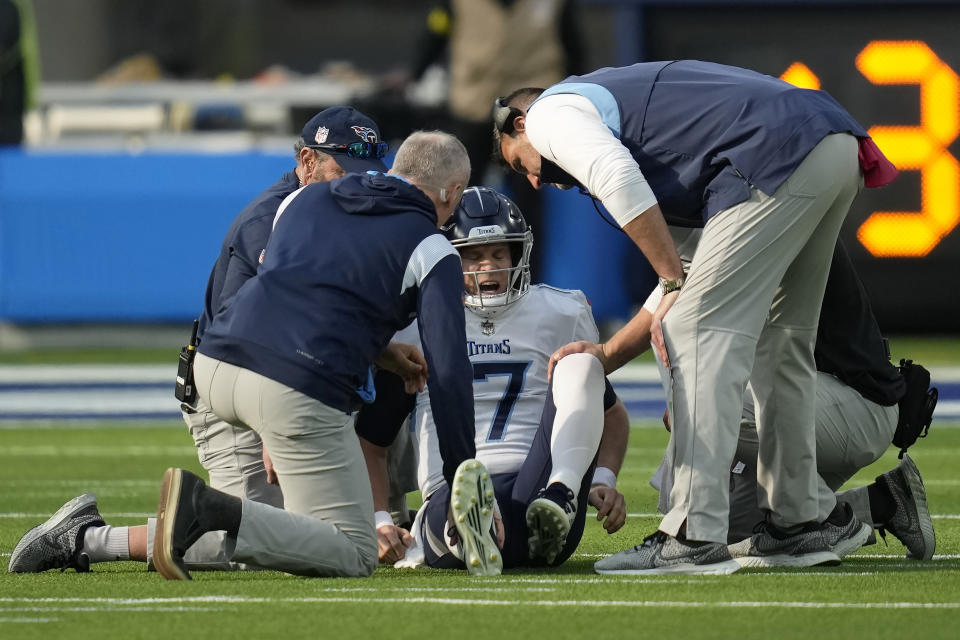 Tennessee Titans head coach Mike Vrabel, right, and trainers check on quarterback Ryan Tannehill, middle, during the first half of an NFL football game against the Los Angeles Chargers in Inglewood, Calif., Sunday, Dec. 18, 2022. (AP Photo/Ashley Landis)