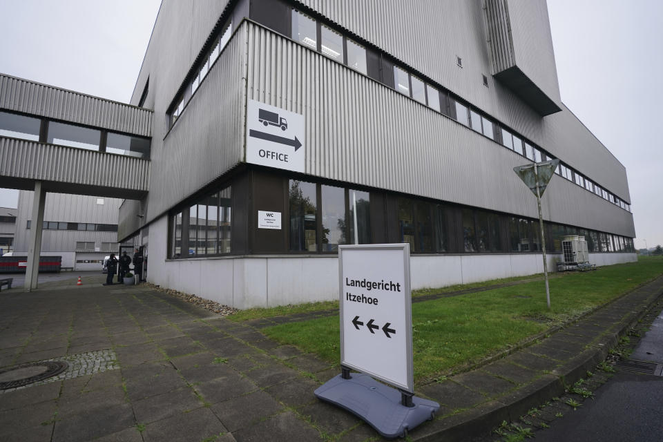 "Itzehoe District Court" is written on a signpost at the China Logistic Center, where the Itzehoe District Court is hearing the trial of a 96-year-old former secretary to the SS commander of the Stutthof concentration campin Itzehoe, Germany, Tuesday, Oct. 19, 2021. The woman is charged of more than 11,000 counts of accessory to murder. Prosecutors argue that the 96-year-old woman was part of the apparatus that helped the Nazi camp function more than 75 years ago. (Markus Brandt/DPA via AP)