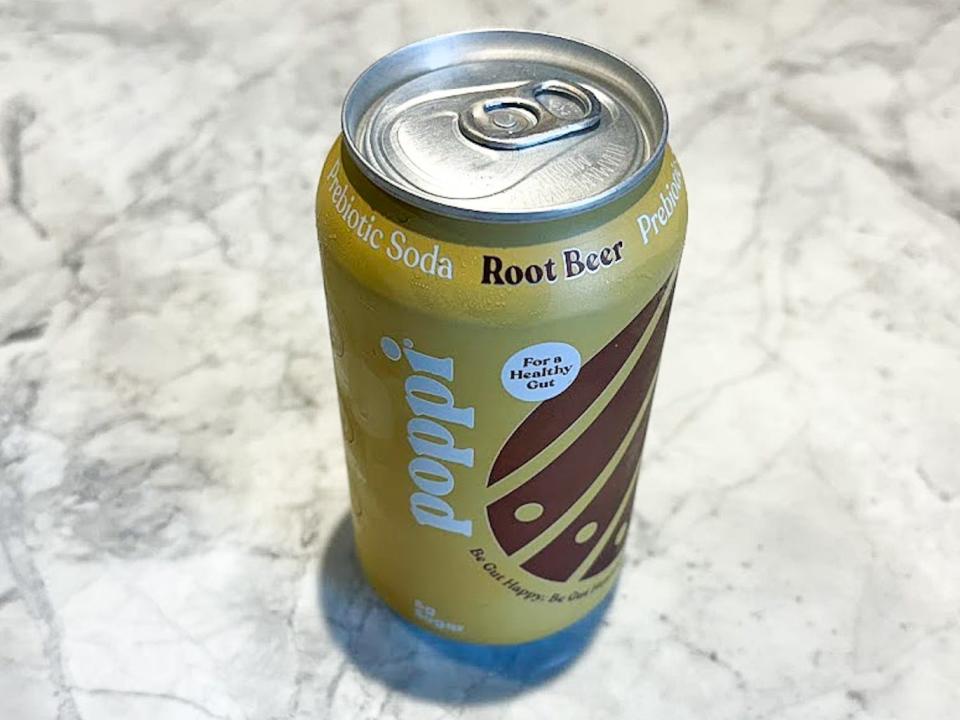 An unopened can of Poppi root beer on a countertop.