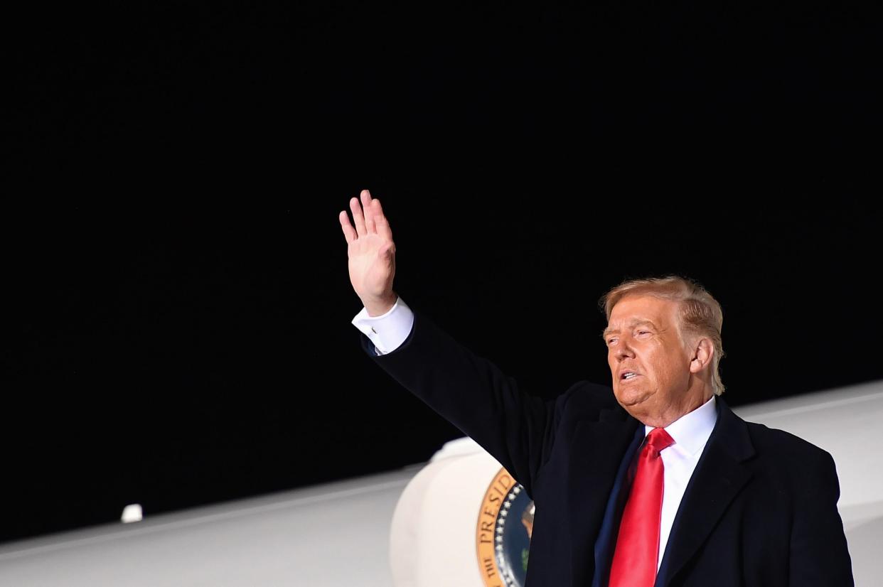 US president Donald Trump waves at supporters, hours after promoting 