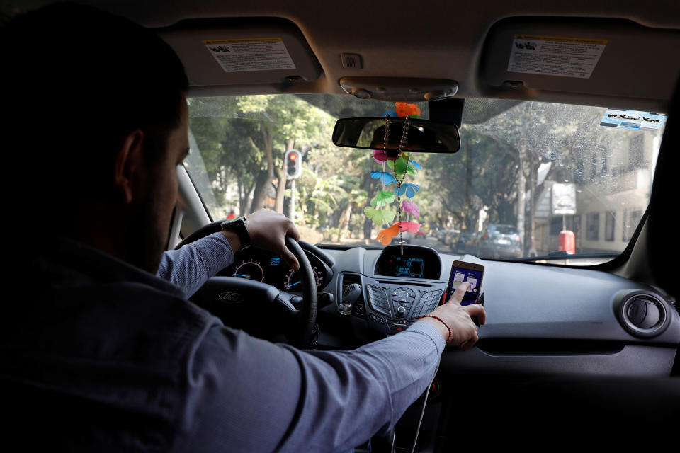 An Uber driver checks the Uber app inside his car in Mexico City, Mexico.&nbsp; (Photo: Carlos Jasso / Reuters)