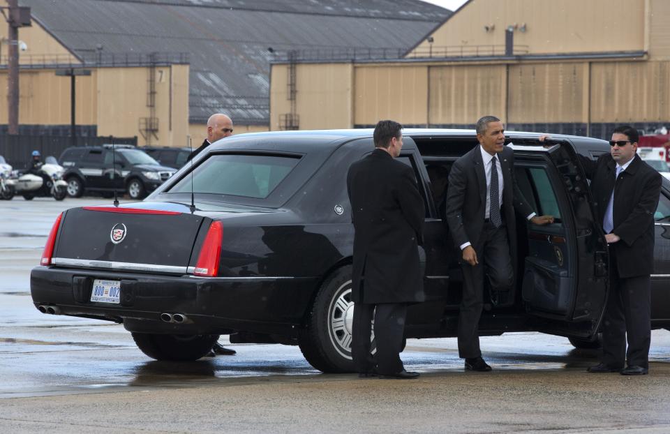 President Barack Obama arrives via motorcade in a light snow, Wednesday, Feb. 26, 2014, at Andrews Air Force Base, Md. before boarding Air Force One for a trip to St. Paul, Minn. In Minnesota he is expected to speak at Union Depot rail and bus station with a proposal asking Congress for $300 billion to update the nation's roads and railways, and about a competition to encourage investments to create jobs and restore infrastructure as part of the President’s Year of Action. (AP Photo/Jacquelyn Martin)
