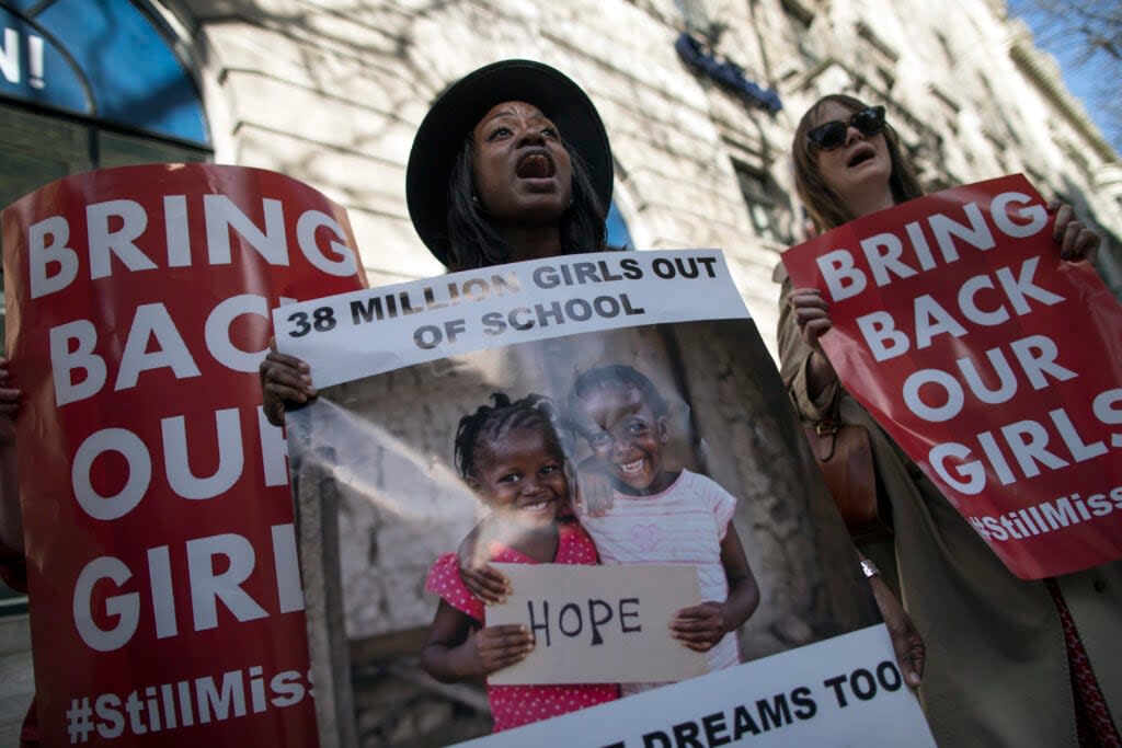 Women hold a signs as other protesters gather outside Nigeria House to mark the one year anniversary since a group of Nigerian schoolgirls were abducted on April 14, 2015 in London, England. (Photo by Dan Kitwood/Getty Images)