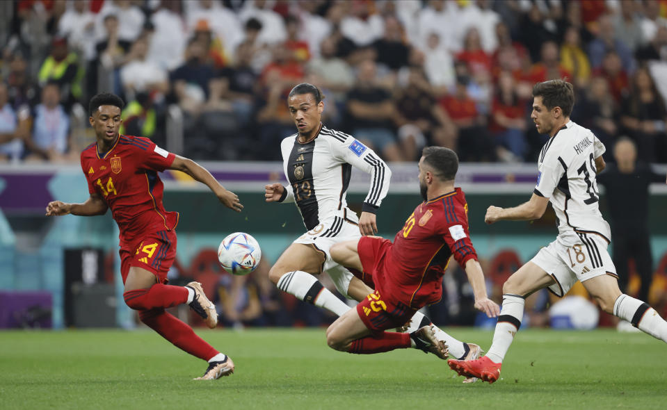 AL KHOR, QATAR - NOVEMBER 27: Alejandro Balde of Spain and Leroy Sane of Germany and Dani Carvajal of Spain challenge during the FIFA World Cup Qatar 2022 Group E match between Spain and Germany at Al Bayt Stadium on November 27, 2022 in Al Khor, Qatar. (Photo by Richard Sellers/Getty Images)