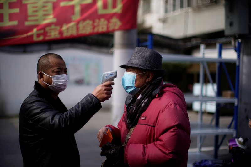 A man checks the temperature on a street in Qibao, an old river town on the outskirts of Shanghai