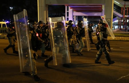 Riot police officers patrol the road during an anti-government protest in Tai Po district, in Hong Kong