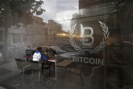 People sit inside the Bitcoin Embassy in Tel Aviv February 2, 2014. REUTERS/Baz Ratner