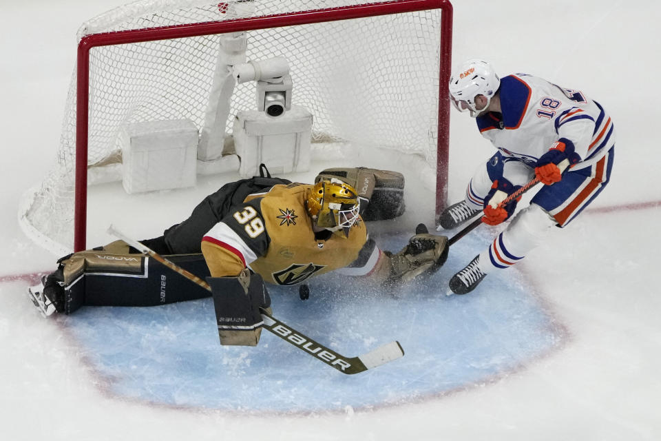 Vegas Golden Knights goaltender Laurent Brossoit (39) blocks a shot by Edmonton Oilers left wing Zach Hyman (18) during the second period of Game 2 of an NHL hockey Stanley Cup second-round playoff series Saturday, May 6, 2023, in Las Vegas. (AP Photo/John Locher)