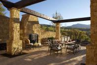 The outdoor dining space overlooks the mountains.