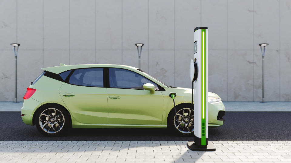 An electric vehicle at a charging station in the city. All items in the scene are 3D, charging station and concept cars are not based on any real ones.