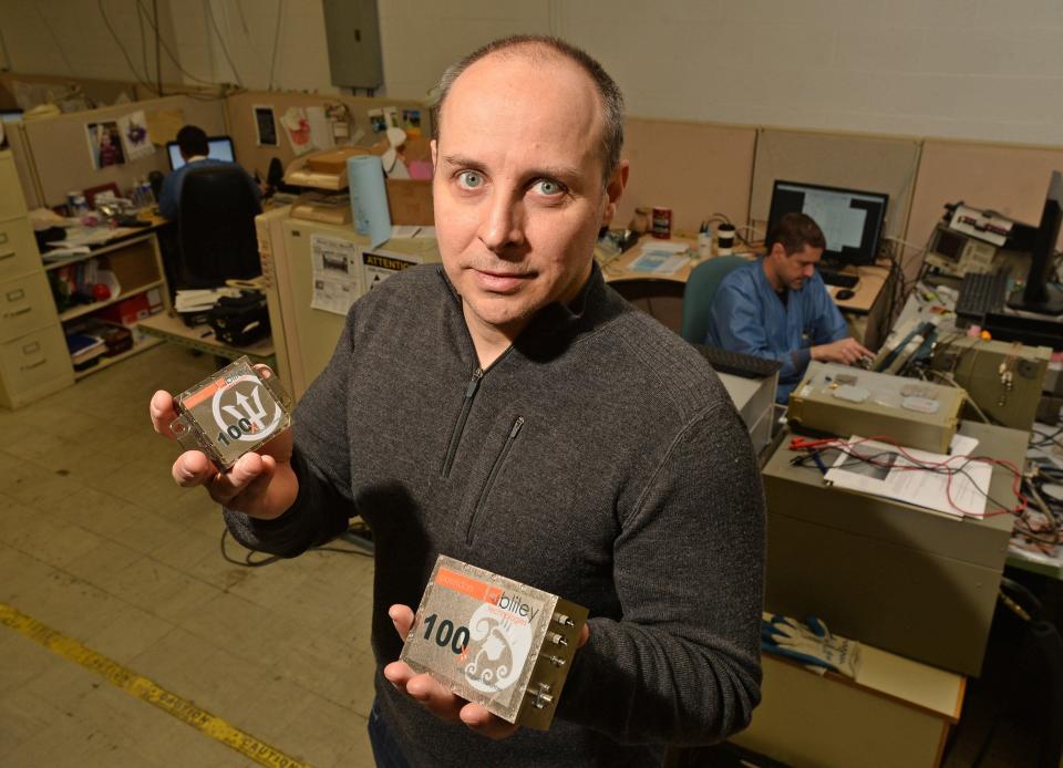 Keith Szewczyk, formerly of Bliley Technologies, now Kyocera AVX, shows off two types of oscillators the company manufactures in this 2018 file photo.