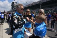 Ed Carpenter talks with his family during qualifications for the Indianapolis 500 auto race at Indianapolis Motor Speedway, Saturday, May 18, 2024, in Indianapolis. (AP Photo/Darron Cummings)