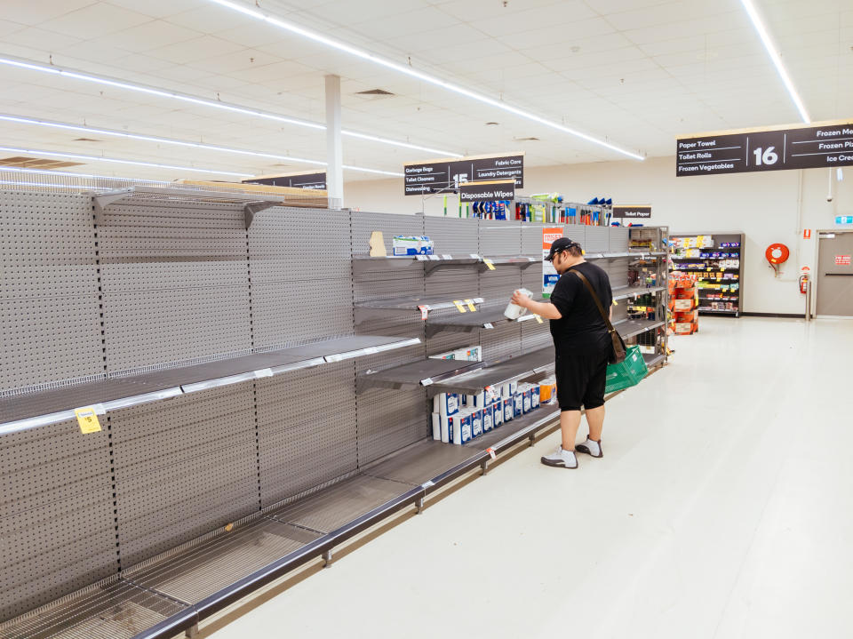 MELBOURNE, AUSTRALIA - MARCH 4, 2020: A man looks for toilet paper in an Australian supermarket after panic buying due to the Corona Virus