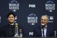 Shohei Ohtani wins the Commissioner's Historic Achievement Award from Rob Manfred before Game 1 in baseball's World Series between the Houston Astros and the Atlanta Braves Tuesday, Oct. 26, 2021, in Houston. (AP Photo/Ashley Landis)