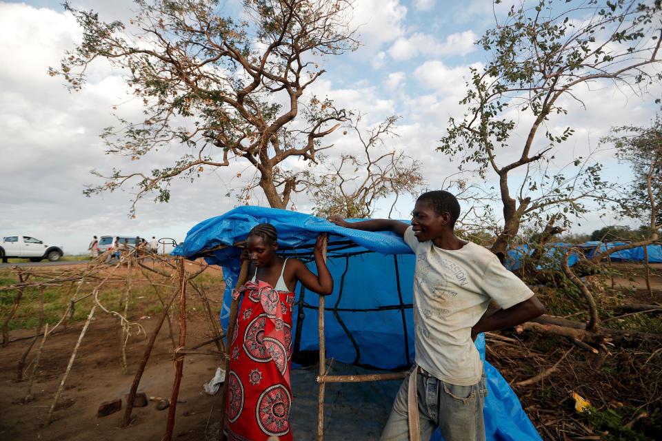 Maria Jofresse, 25, listens while her husband Albano Arnando, 34, chats with neighbors as they stand beside their tent at a camp for displaced people in the aftermath of Cyclone Idai, in John Segredo, near Beira, Mozambique April 2, 2019. (Photo: Zohra Bensemra/Reuters) 