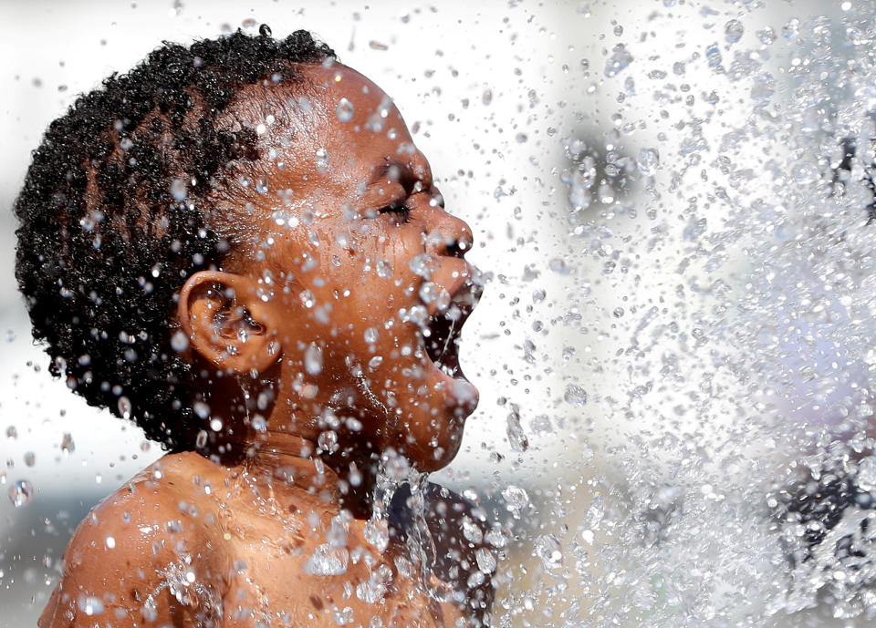 <p>A boy plays in a fountain on a hot summer day in Brussels, Belgium, Aug. 6, 2018. (Photo: Yves Herman/Reuters) </p>