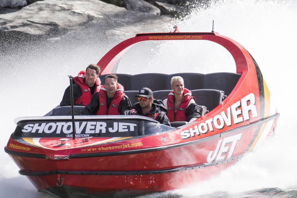 Biebs boards a boat and looks, well bored...