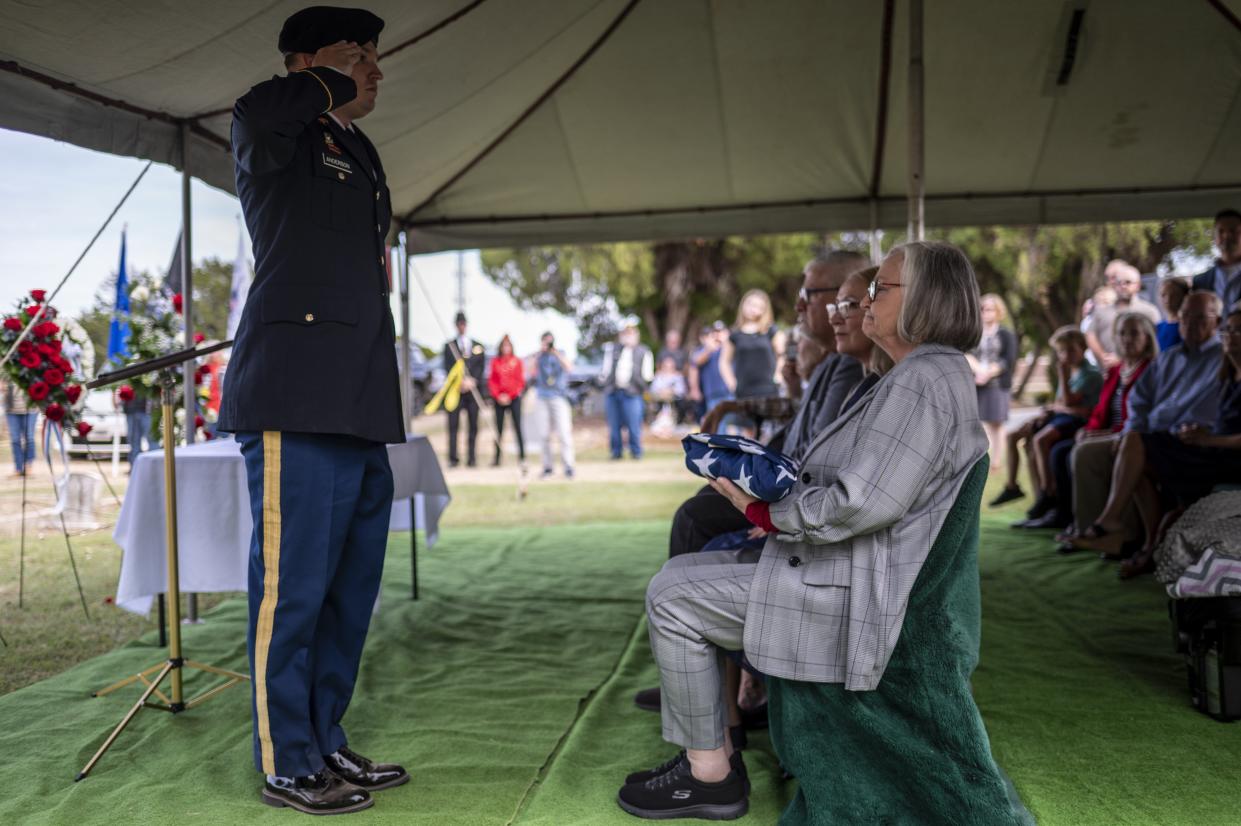 Jackie James, niece of Sgt. Turner Yearwood Johnston, is given a folded American flag at his funeral on Saturday Oct. 21, 2023 in Belton, TX. Johnston's remains were returned and buried in Belton 80 years after he died in World War II.