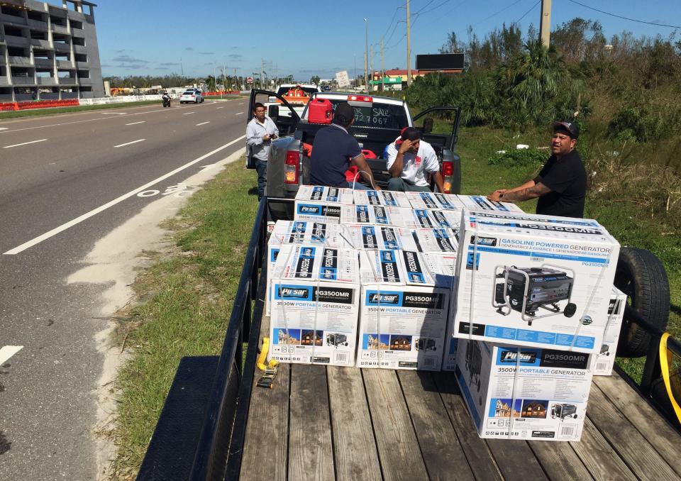 A man who only identified himself as Gilbert, left at truck door, was selling 3500 watt portable generators for $750 along U.S. 41 in Port Charlotte following Hurricane Ian on Friday, Sept. 30, 2022. .  Gilbert said he drove the rented truck from Houston with the flatbed trailer loaded with generators and was willing to show potential buyers he paid $500 for each one. Considering it is a sixteen-hour drive from Houston, he felt it was a fair price. He wasn't having trouble finding willing buyers. 