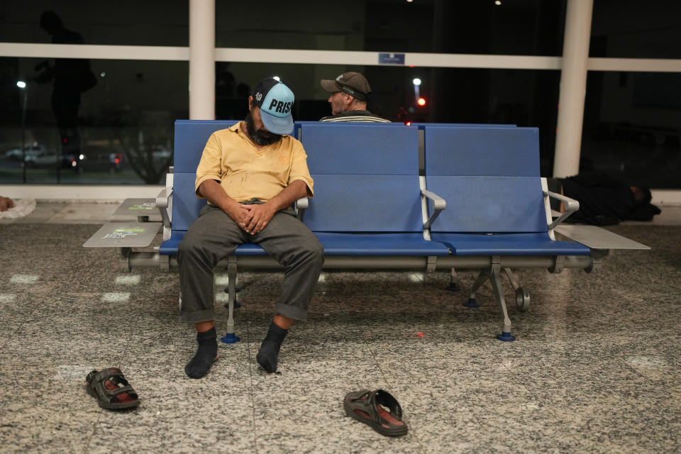 A homeless men sleep at the Jorge Newbery international airport, commonly known as Aeroparque, in Buenos Aires, Argentina, Thursday, April 6, 2023. More than 100 homeless people sleep every night in a common area of Aeroparque. (AP Photo/Natacha Pisarenko)