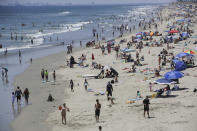 Visitors crowd the beach Saturday, June 27, 2020, in Huntington Beach, Calif. (AP Photo/Marcio Jose Sanchez)
