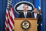 FBI Director Christopher Wray speaks during a virtual news conference at the Department of Justice, Wednesday, Oct. 28, 2020 in Washington, as Assistant Attorney General for National Security John Demers looks on. The Justice Department has charged eight people with working on behalf of the Chinese government to locate Chinese dissidents and political opponents living in the U.S. and coerce them into returning to China. Five of the eight were arrested Wednesday morning. (Sarah Silbiger/Pool via AP)