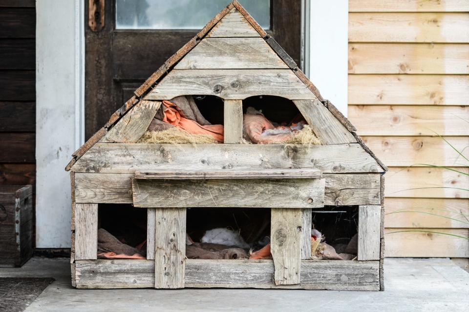 A cat hotel sits on the porch of a home on Wednesday, July 19, 2023 in the Bates-Hendricks neighborhood of Indianapolis.