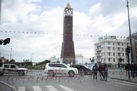 Security forces stand guard in Tunis' landmark Avenue Habib Bourgiba, where massive protests took place in 2011, on the tenth anniversary of the uprising, during a national lockdown after a surge in COVID-19 cases, in Tunis, Thursday, Jan. 14, 2021. Tunisia is commemorating the 10th anniversary since the flight into exile of its iron-fisted leader, Zine El Abidine Ben Ali, pushed from power in a popular revolt that foreshadowed the so-called Arab Spring. But there will be no festive celebrations Thursday marking the revolution in this North African nation, ordered into lockdown to contain the coronavirus. (AP Photo/Mosa'ab Elshamy)